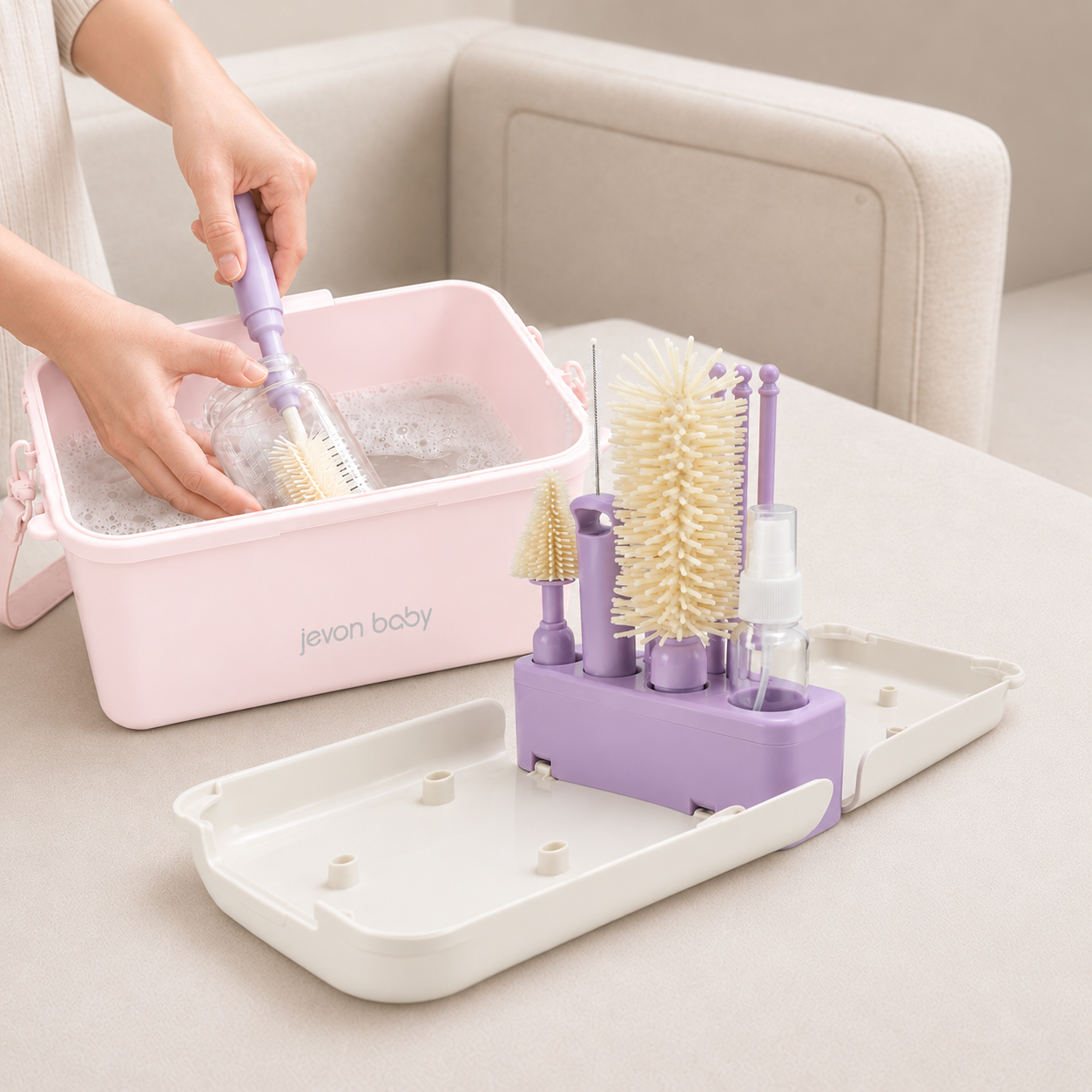 A person's hands washing a baby bottle in soapy water inside the CleanPod by using Jevonbaby Travel Bottle Brush.