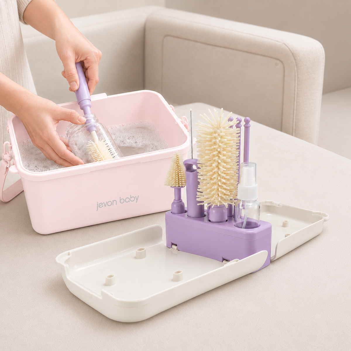 A person's hands washing a baby bottle in soapy water inside the CleanPod by using Jevonbaby Travel Bottle Brush.